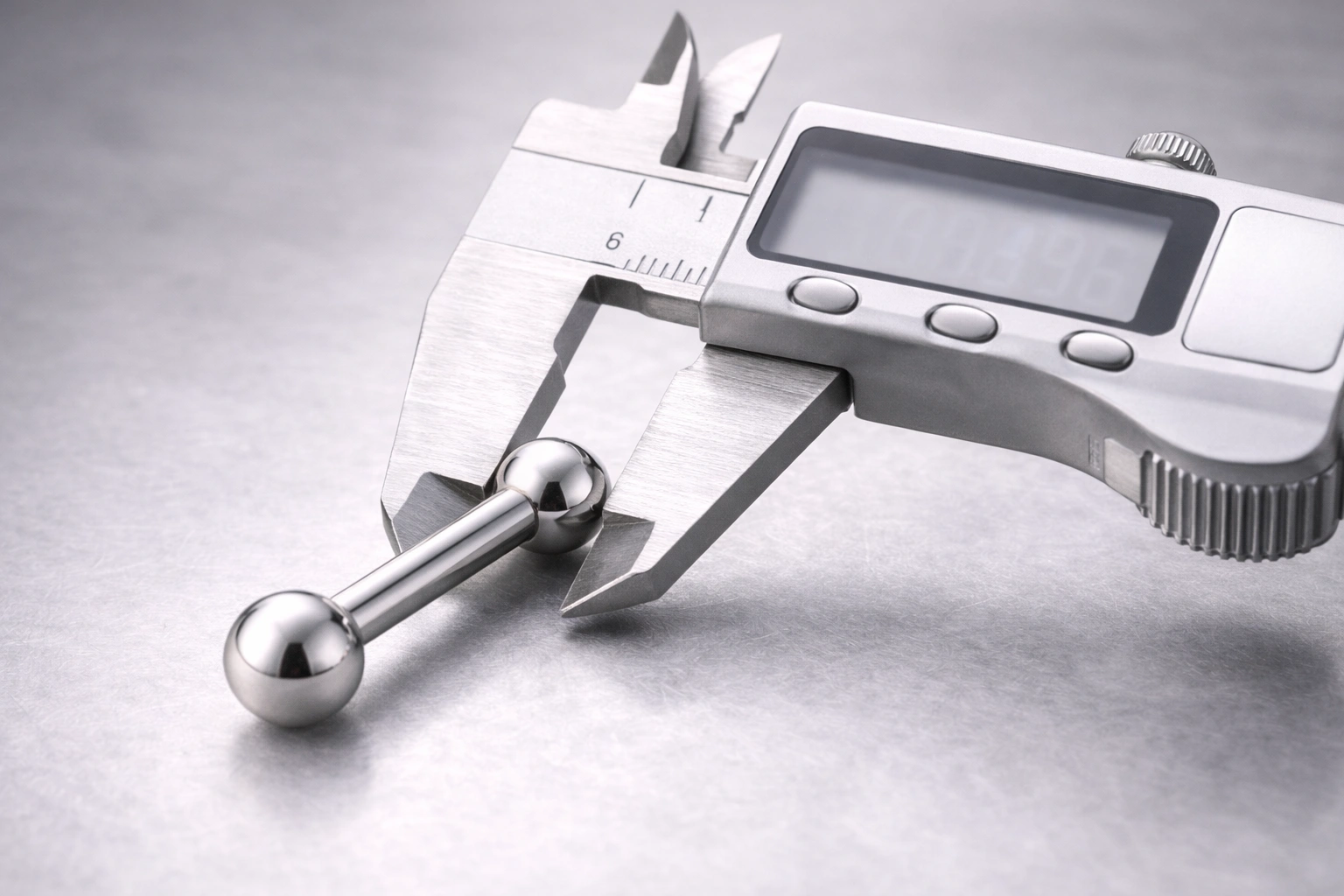 Quality control measurement with caliper on titanium barbell