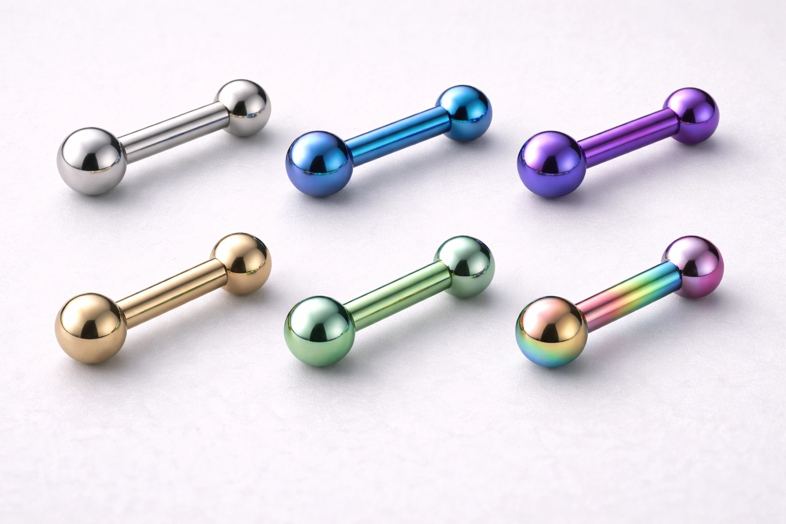 Titanium jewelry finishes close-up showing mirror polish and anodized colors