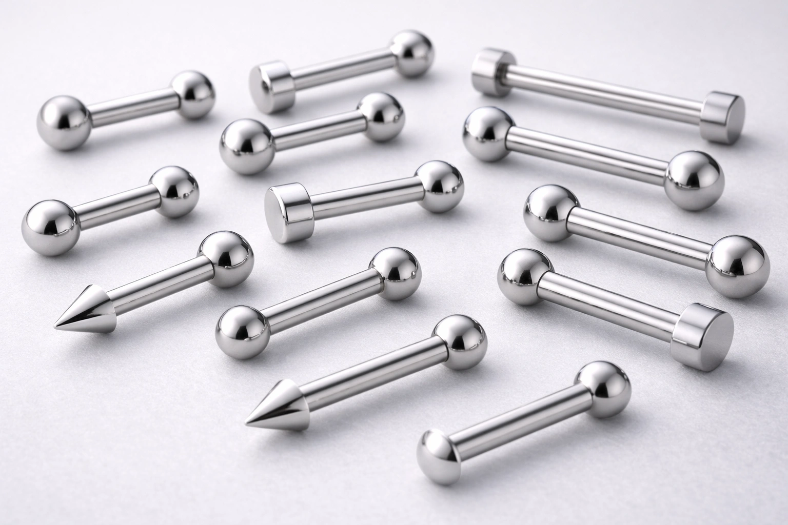 Implant-grade titanium barbells on clean studio surface, product macro photo